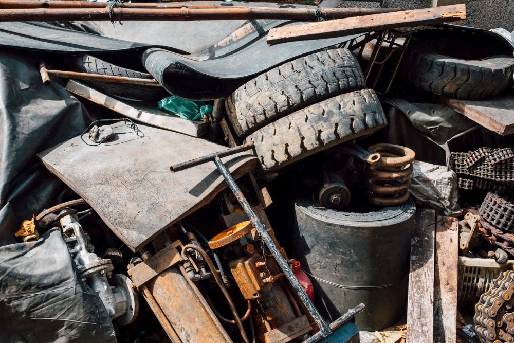 A stack of worn tires alongside other junk, showcasing a specialized junk removal service operating in Jacksonville, FL.
